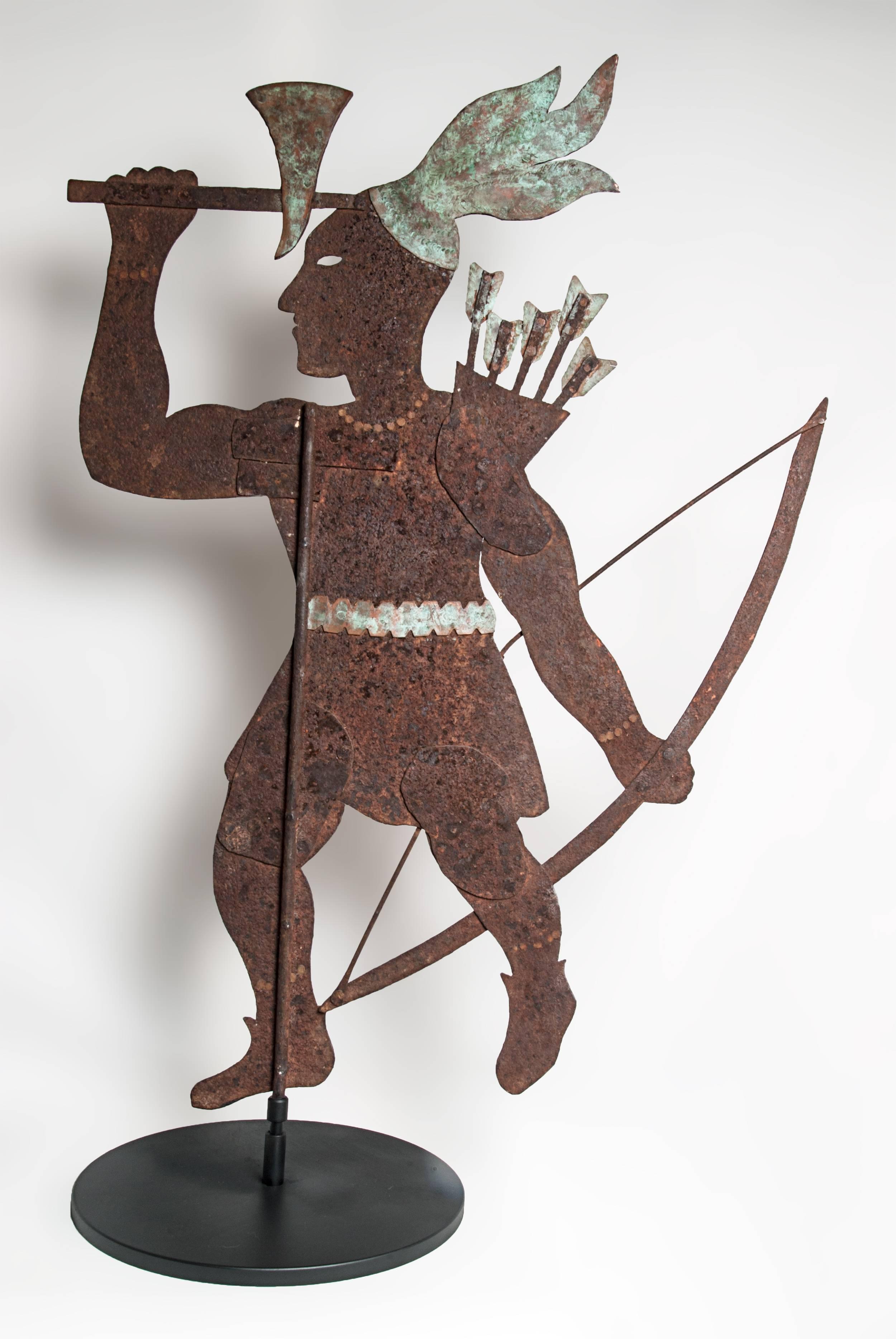 $4800
Silhouette Indian weathervane with cut-out eyes. Made of metal and copper. Constructed of multiple pieces of iron riveted together with sheet copper used for the hatchet, belt, arrows and feathers. Weathered and oxidized showing the natural