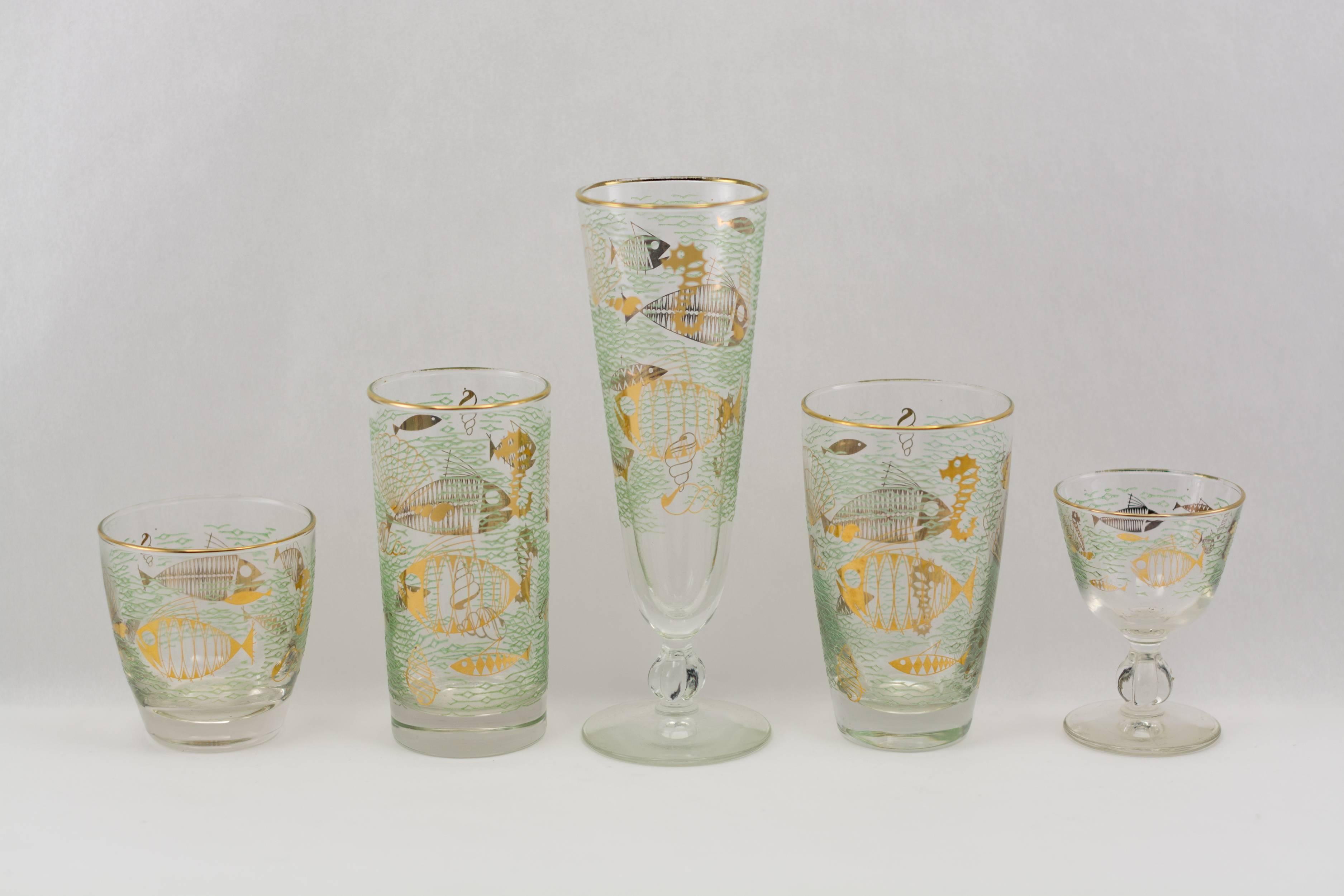 Libbey “Marine Life” Barware
60-piece suite of vintage barware by Libbey Glassware
with stylized fish, seahorses and shells in 22 karat gold against
a ground of raised translucent green enamel “waves”.
The suite consists of 12 each of five