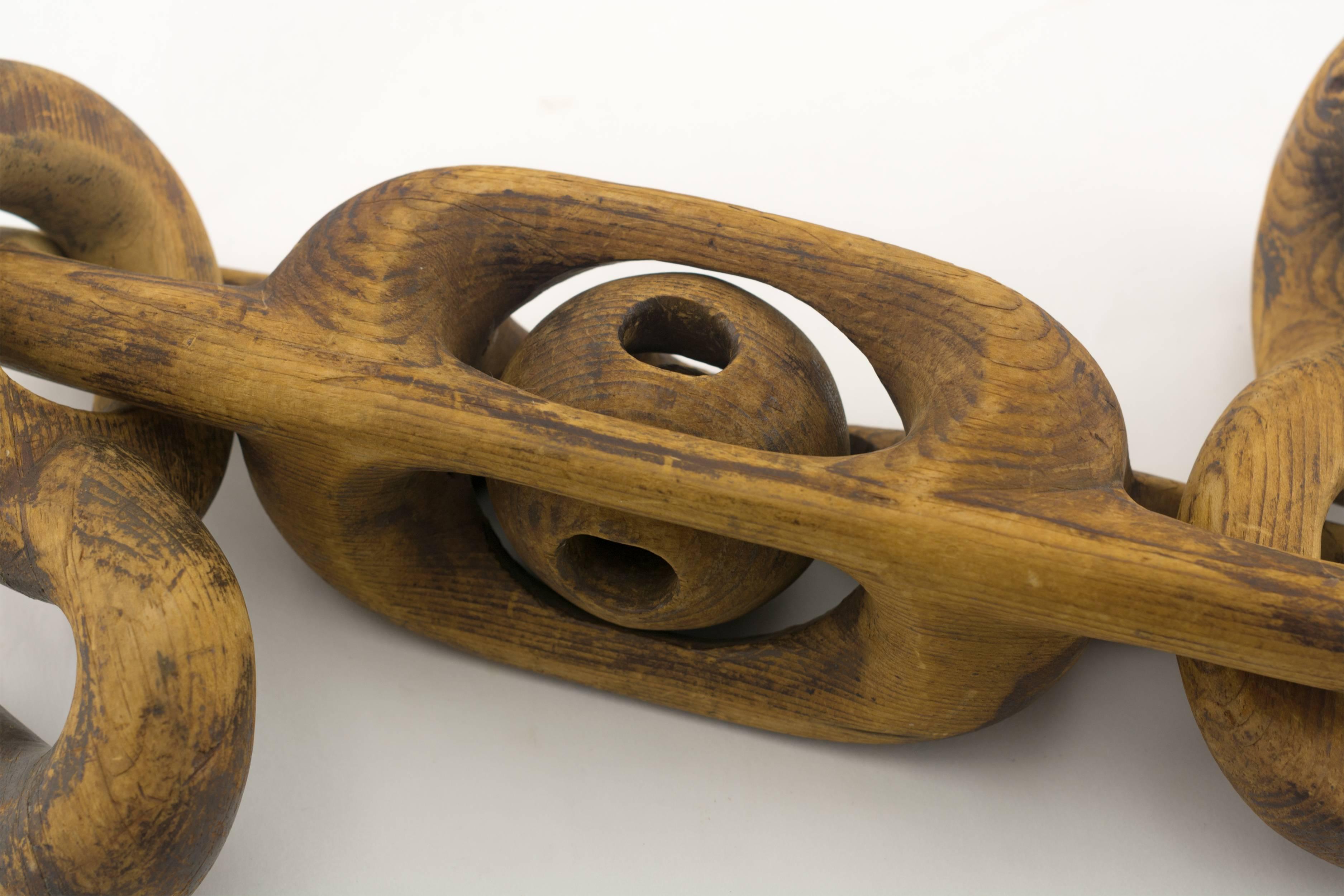 Carved from a single piece of wood with two hooked ends, one hook in the form of a serpent the other a duck. In between is a caged ball. Most likely sailor made.
American, circa 1875.
 