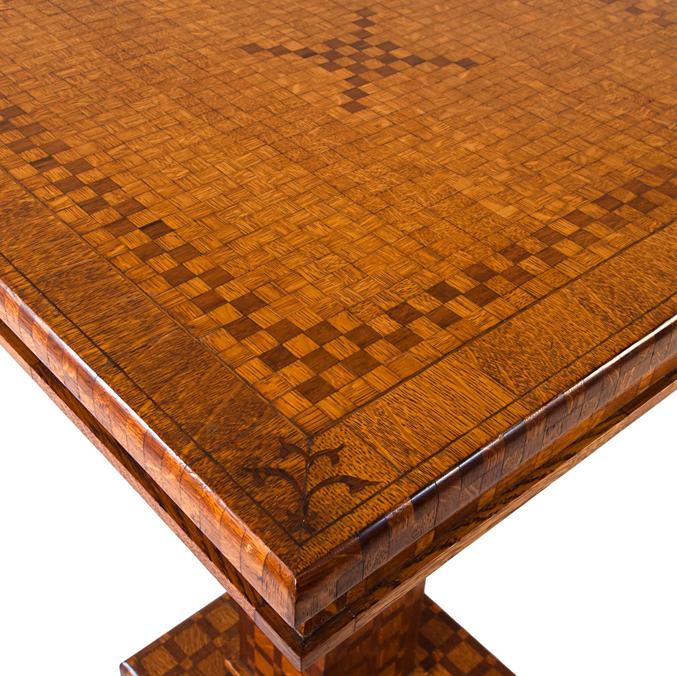 Late 19th century American marquetry table with contrasting checkerboard design throughout. Made of various woods including Oak, Pine and Fruitwoods.The top is mounted to a square pillar support on top of a raised stepped plinth. c.1860

