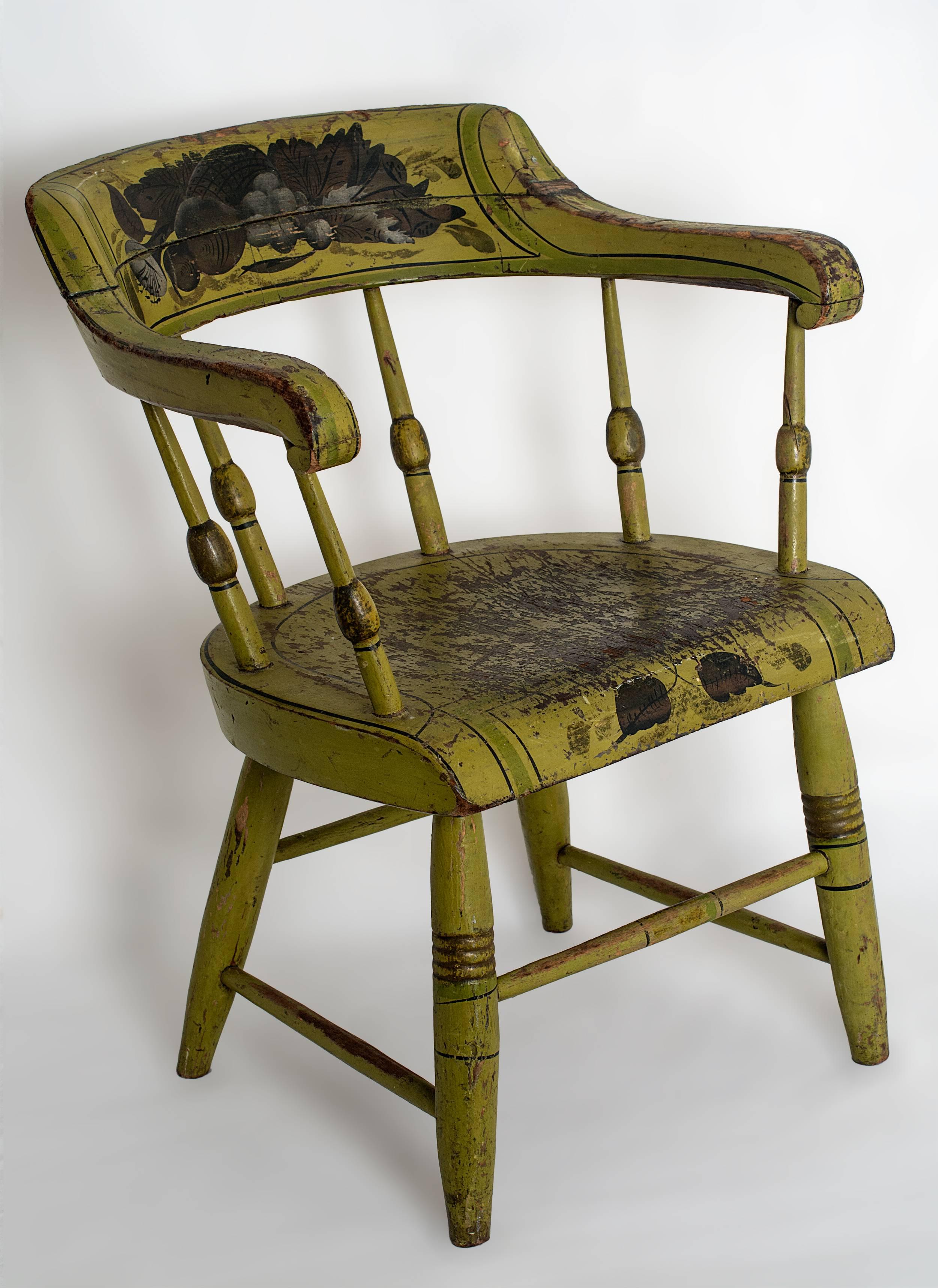 Apple green painted child’s firehouse chair with shaped back and turned
spindles and plank seat. Original paint and floral stenciling
New England, c.1860

