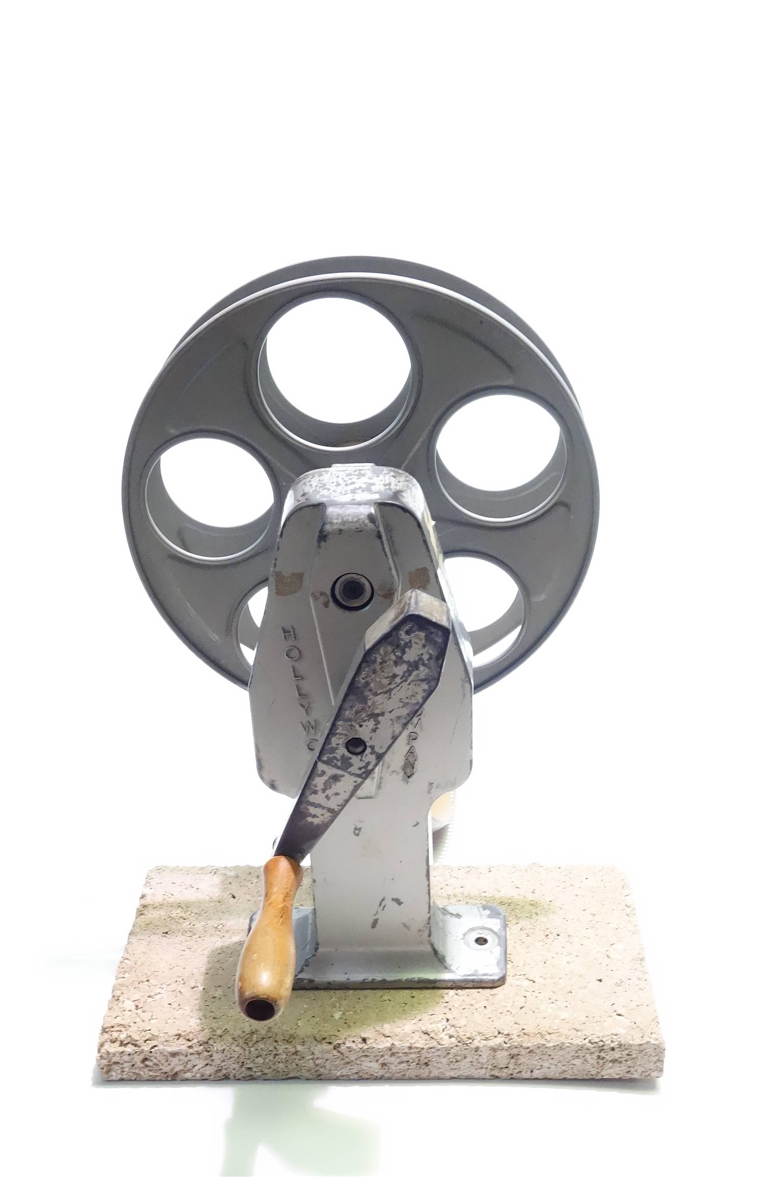 Offered for your consideration is this Cinema 35mm movie professional film rewind with 35mm reel, circa mid-century. Wonderful to display as sculpture.
Very good patina from real usage in a Hollywood film editing studio.

NOTE: Our selling prices
