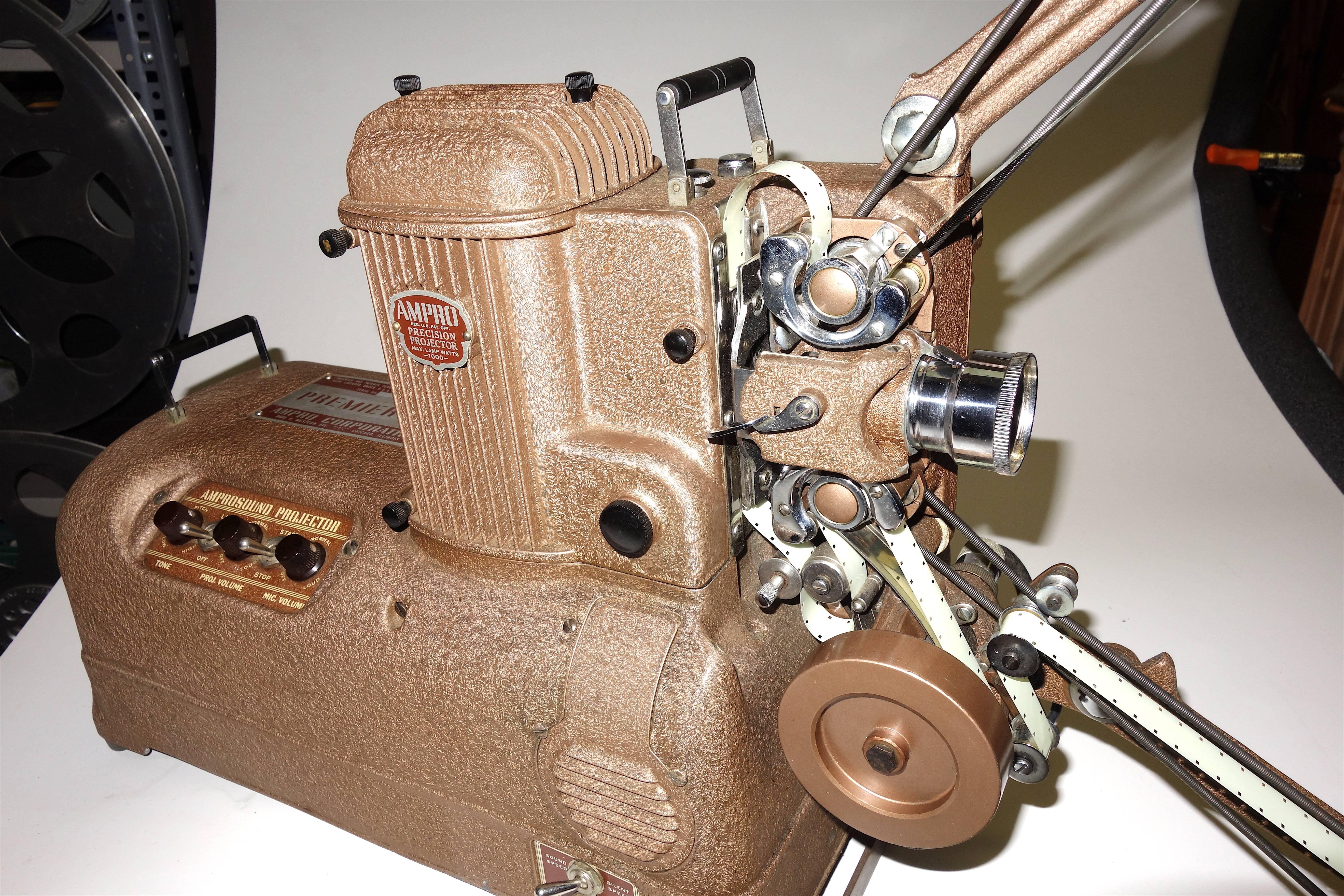 Note: 
This antique may qualify for our Gallery Wide Extra 10-25% Off Sale, 
Going on now.

Submitted for your approval is this circa 1940s, 16mm AMPRO Motion Picture Movie Projector in absolutely pristine condition. Offered as a wonderful Art Deco