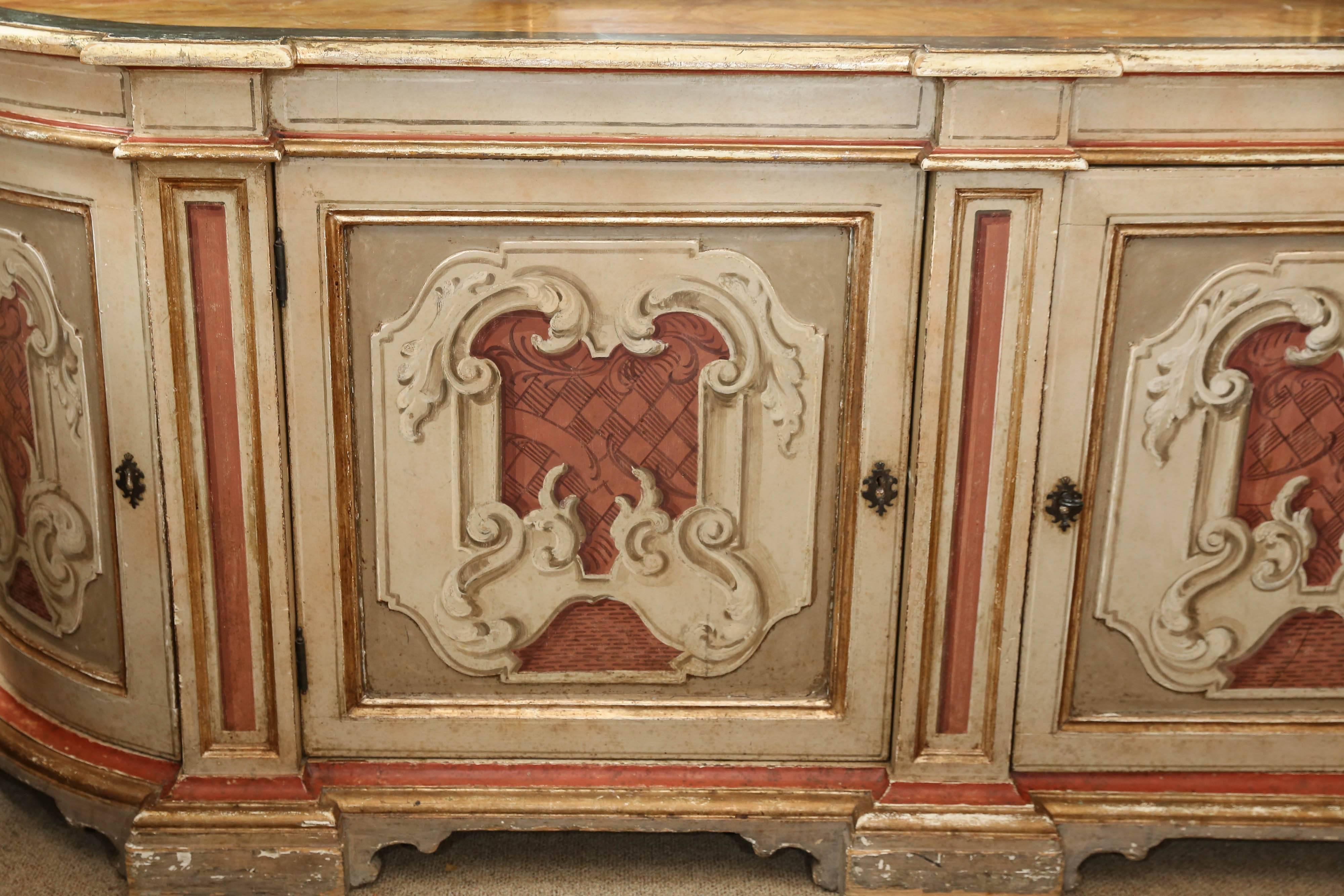 Beautiful faux marble-top finish over a conforming base with two doors
flanked by two rounded doors, each carved and painted with scrolling
design and supports, opens to single shelf interior. Has a key! Pale
gold and deep terracotta colors grace