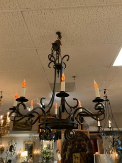 Eight light iron chandelier with scrolling arms