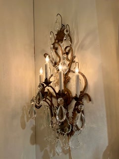 Pair of large iron and crystal five light sconces