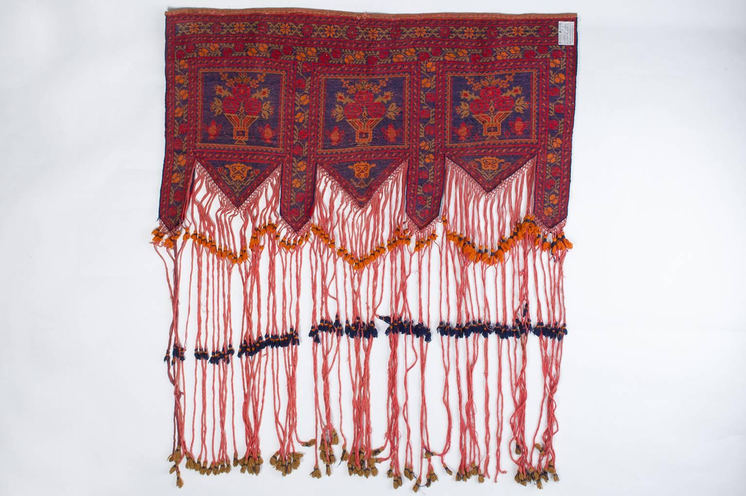 It has never been used, therefore its long fringes are still tied together: it had probably been woved (together the other one) to be a wedding gift, or it had been woven by the bride for her own wedding trousseau. 
At the time of assembly, the