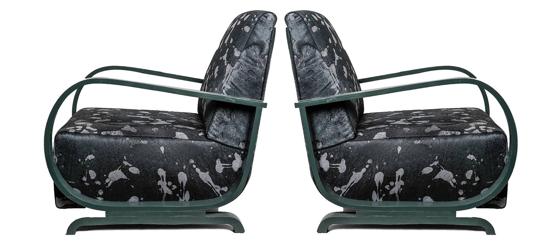 Pair of special  Art Deco club armchairs, green lacquered wood, coated with green dyed cowhide: unique pieces.
All padding has been redone. On request I can prepare padded stool with other pieces of the same leather. Good price for closing