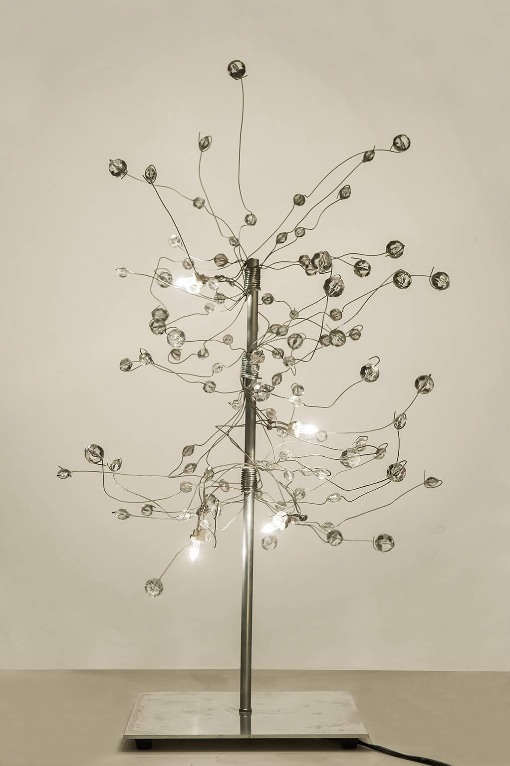 O/5003 -  Table insolite et élégante en forme d'arbre  lampe à led, l'une des premières lampes à led, créée par le  jeune artiste Salih Mehci,  très célèbre en France pour ses incroyables lustres légers et immenses.
Matériaux : Inox et plexiglas.