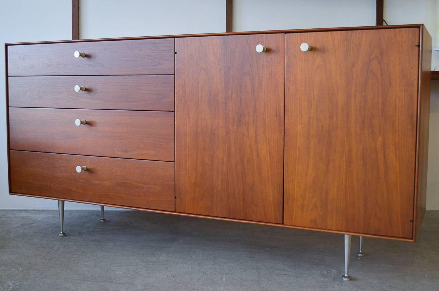 George Nelson for Herman Miller Thin Edge walnut credenza with original hardware and brushed aluminum legs. Fully restored wood in showroom condition.

Measures 67