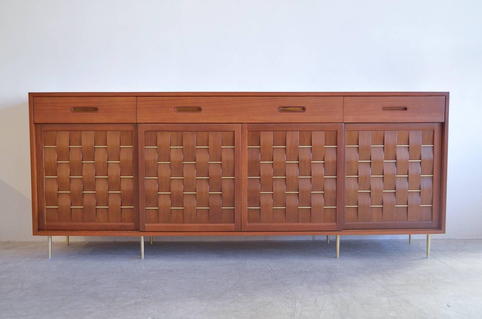 Exceptional and rare ribbon mahogany and brass basketweave front credenza by Edward Wormley for Dunbar of Berne, Indiana.

Professionally restored in perfect showroom condition, this piece has brass rods interwoven into the front and brushed brass