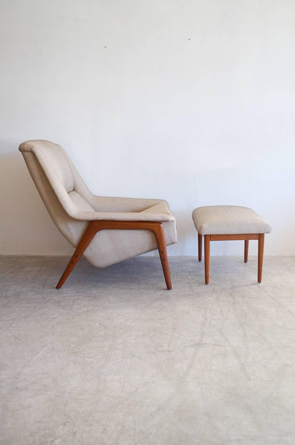 Large teak frame lounge chair and ottoman by Folke Ohlsson for Dux of Sweden. Chair has been professionally restored with beautiful teakwood frame and new foam and classic beige textured upholstery.
Measures: 34