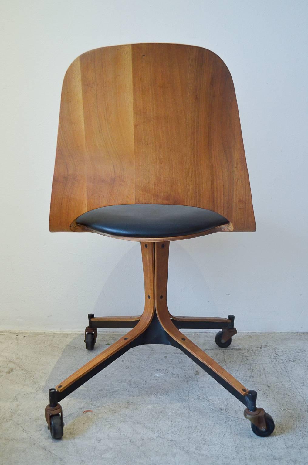 Authentic bentwood swivel desk chair on original casters by George Multiuser for Plycraft, Inc.

Original casters, black Naugahyde seat in very good vintage condition with no tears or rips to the seat. Wheels roll smooth and chair swivels smoothly