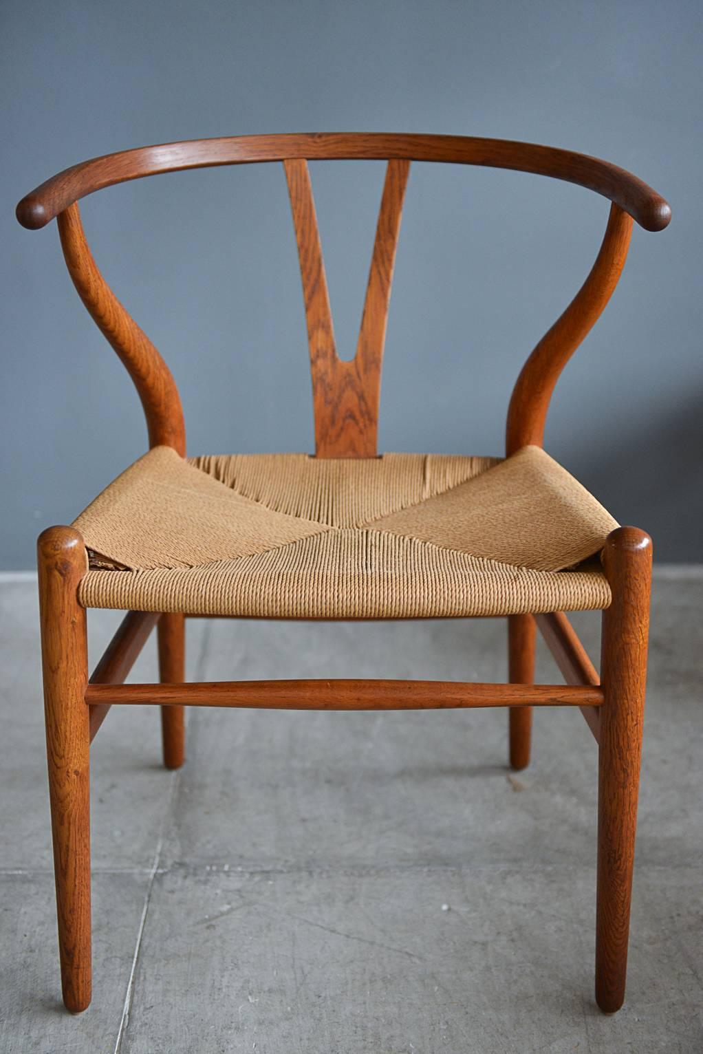 Original set of six Hans Wegner CH24 Wishbone dining chairs. Hand oiled original oak finish with woven seats. Seats are excellent with no breaks in the cord. Beautiful patina. Near perfect matching set.

Classic, iconic design and hard to find in