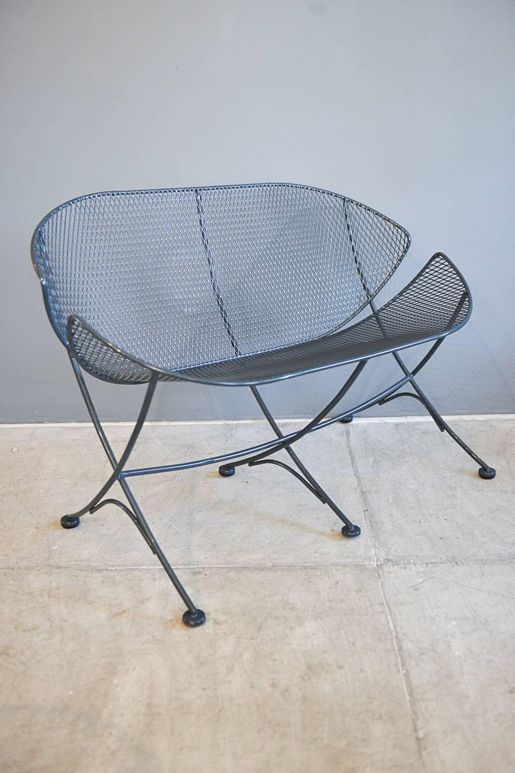 Maurizio Tempestini for Salterini Clamshell patio set. Woven mesh metal has been professionally powder coated and new floor protectors added. Beautiful charcoal grey color.

Set includes: Two chairs, one loveseat, one side table.

Settee