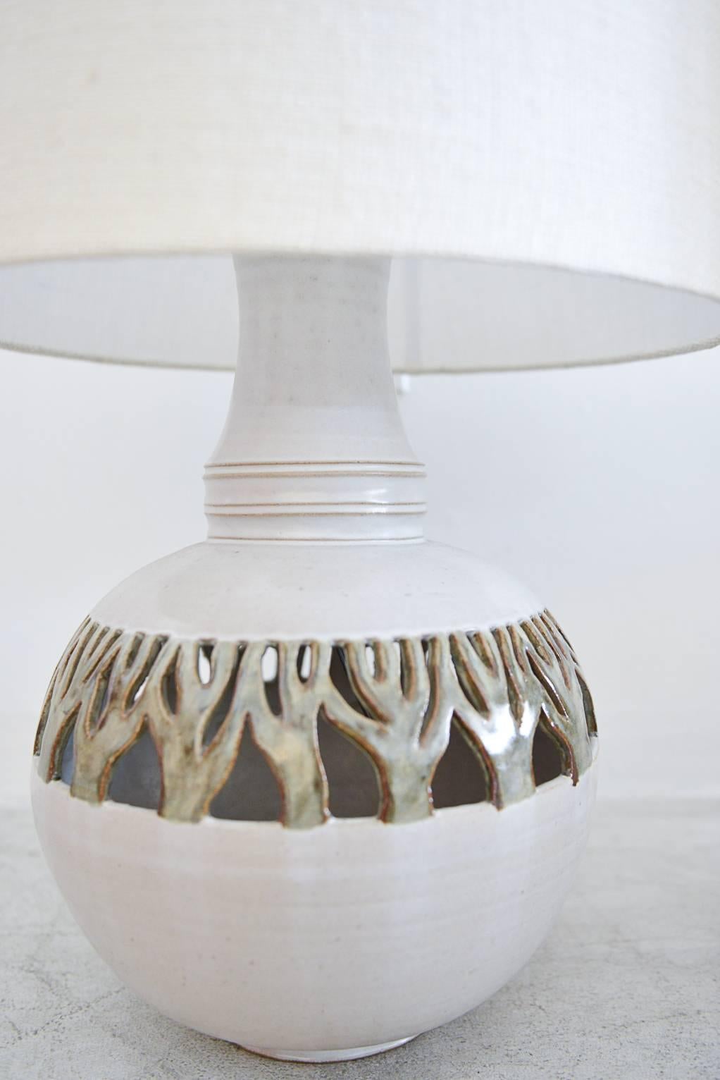 Beautiful pair of substantial custom handmade ceramic cut-out lamps with organic feel. Cut-out design with glazed trim. Signed by the artist, Meredith.

Price includes custom linen shades.

Lamps measure: 12" diameter and 16" H to