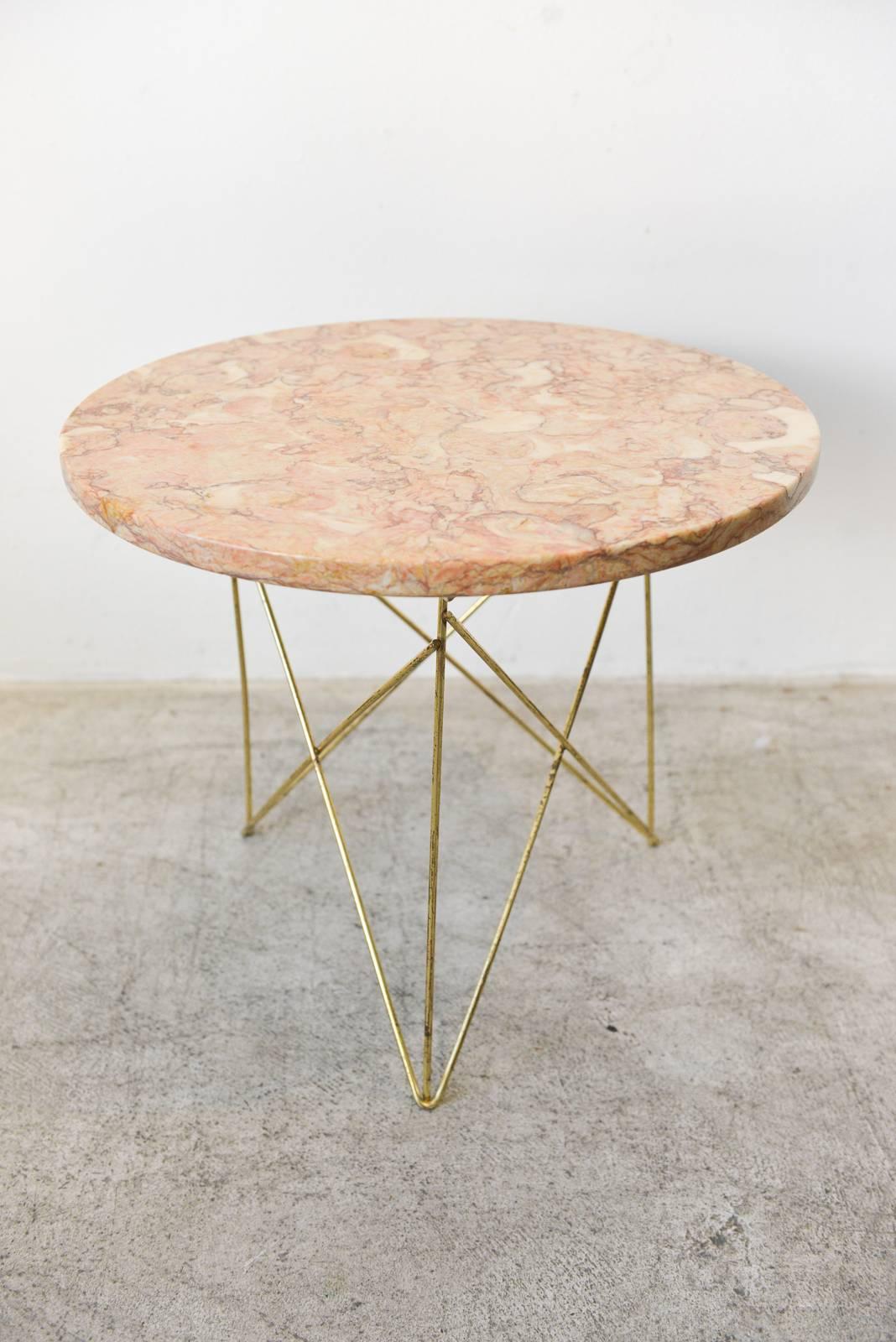 Rene Brancusi marble and brass side or occasional table in beautiful rose marble. Beautiful marble top in very good condition no chips or cracks. Beautiful patina on the brass rod legs. Marble made in Italy. 

Measures 18