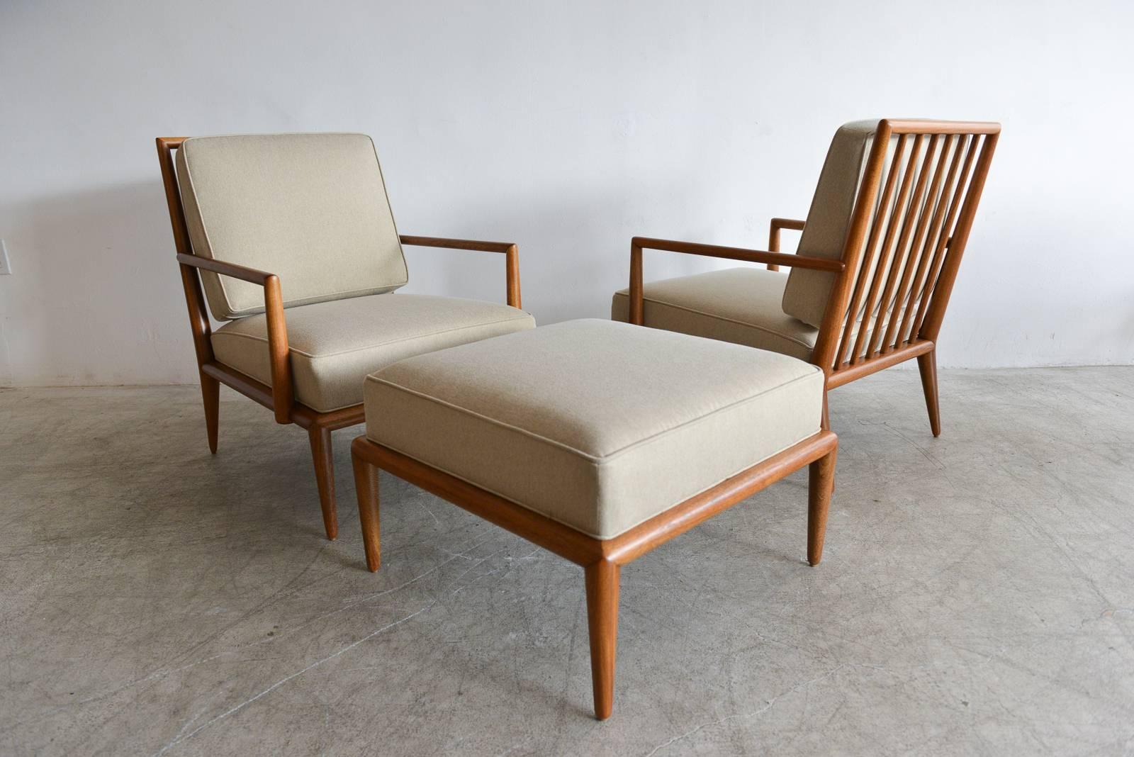 Exceptional pair of T.H. Robsjohn-Gibbings for Widdicomb mahogany spindle back lounge chairs. Professionally restored to showroom condition with new beige cushions and foam. Classic and iconic lines, very comfortable. Matching ottoman also available