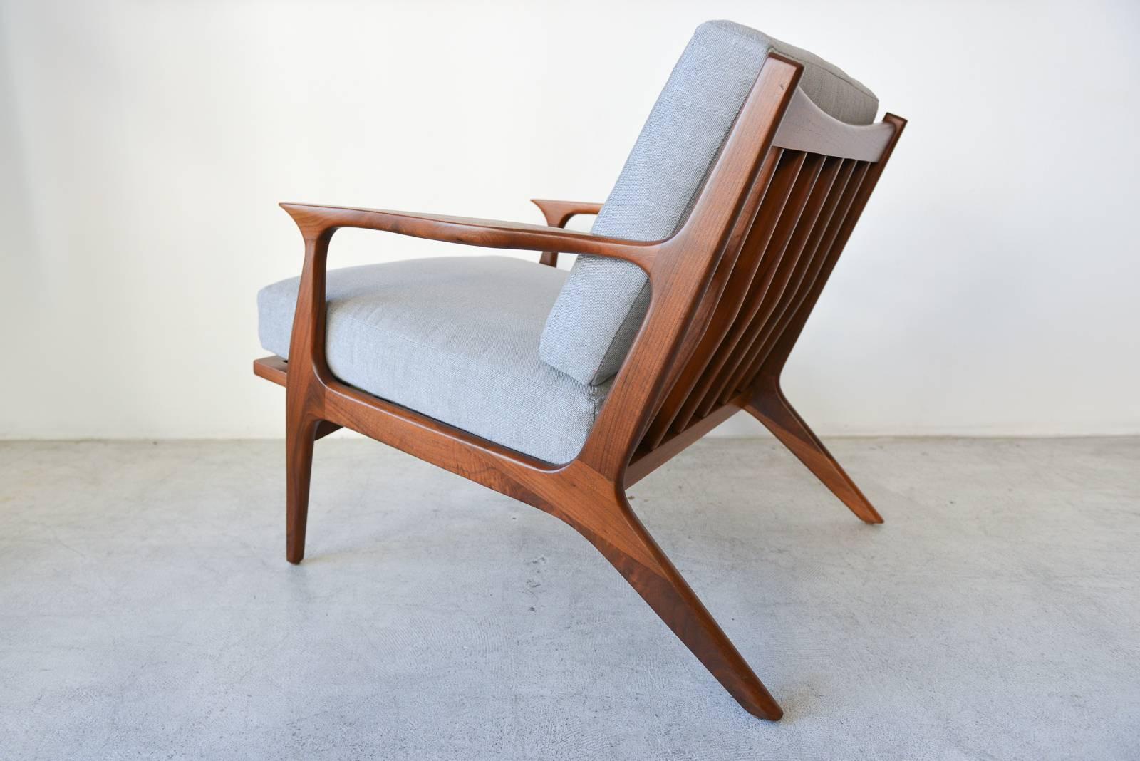 Danish Sculpted Walnut Spindle Back Lounge Chair, circa 1960