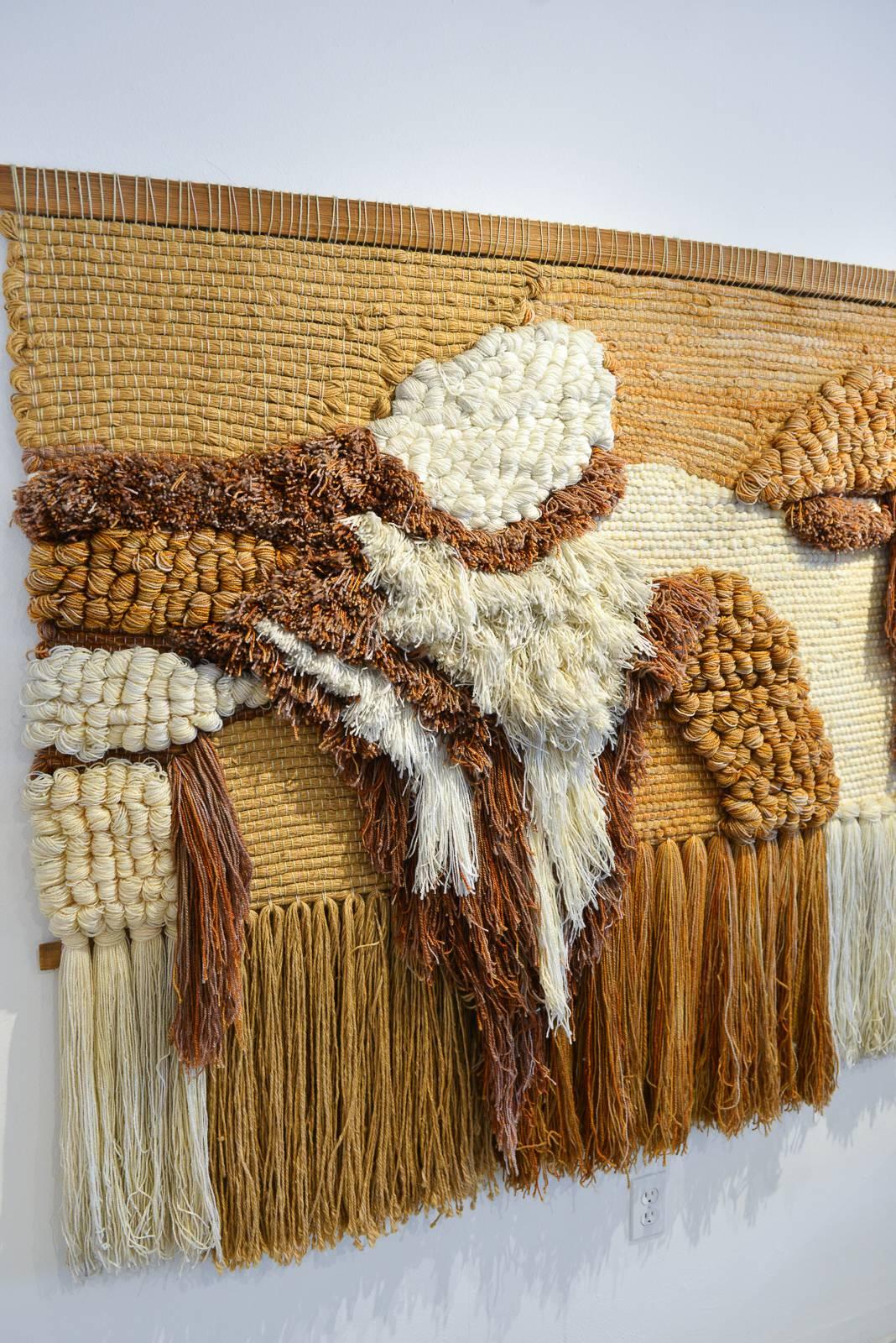 Very large fiber art textile wall hanging. Beautifully crafted with wood yarn and fiber, this very large piece would be a statement on any wall.

Excellent original condition with upper and lower wood supports. No breaks or unravelling of weave.