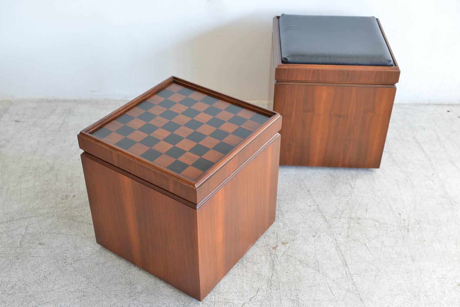 Pair of walnut checkerboard or chess game cube ottomans, circa 1965. Fully restored in showroom condition with original black vinyl covers. Boxes open up for storage and tops are reversible with cushion on one side and game table on the other. Great