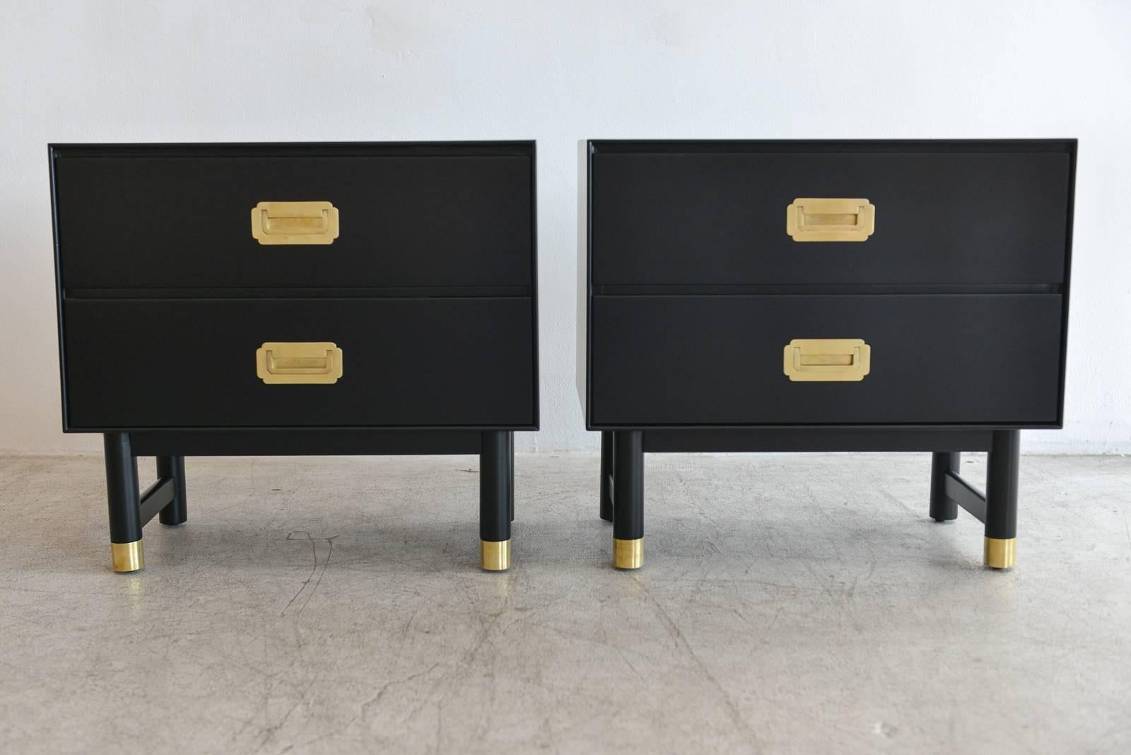 Pair of black lacquer and brass Campaign nightstands, circa 1960 by Barker Brothers Furniture. Professionally restored in showroom perfect condition with polished brass hardware and brass tipped front legs. Sold as a pair only. Beautiful as side