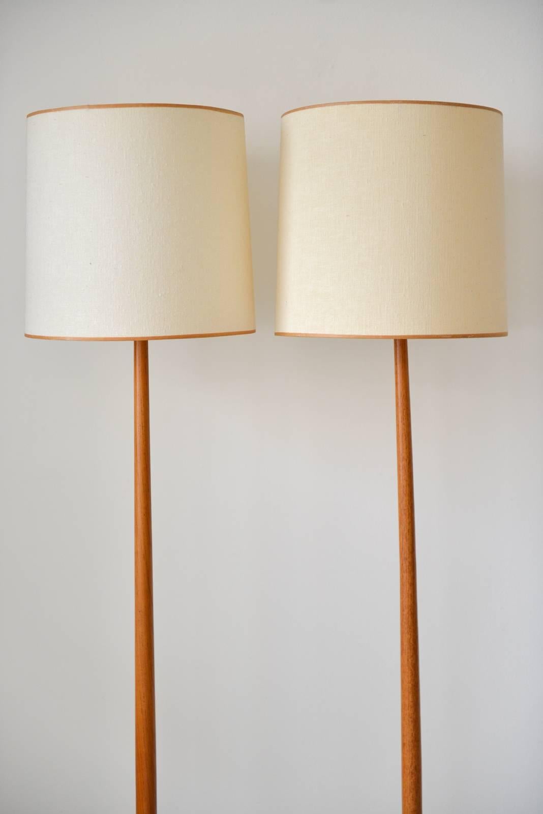 Pair of Swedish teak floor lamps for George Kovacs, circa 1960. Original shades with tan piping and original cords. Signed on underside with Made in Sweden label and Kovacs stamp. Excellent original condition. 

Can be seen in our showroom at MODERN