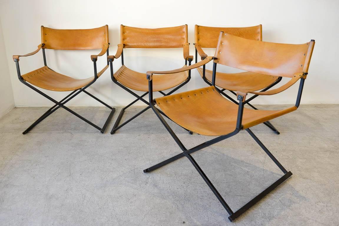 Saddle leather and iron directors chairs, circa 1970. Beautiful patina to the hand oiled saddle leather with great details like swiveling armrests and brass rivoting. Leather has a wonderful warm patina but is not overly worn. Very comfortable and