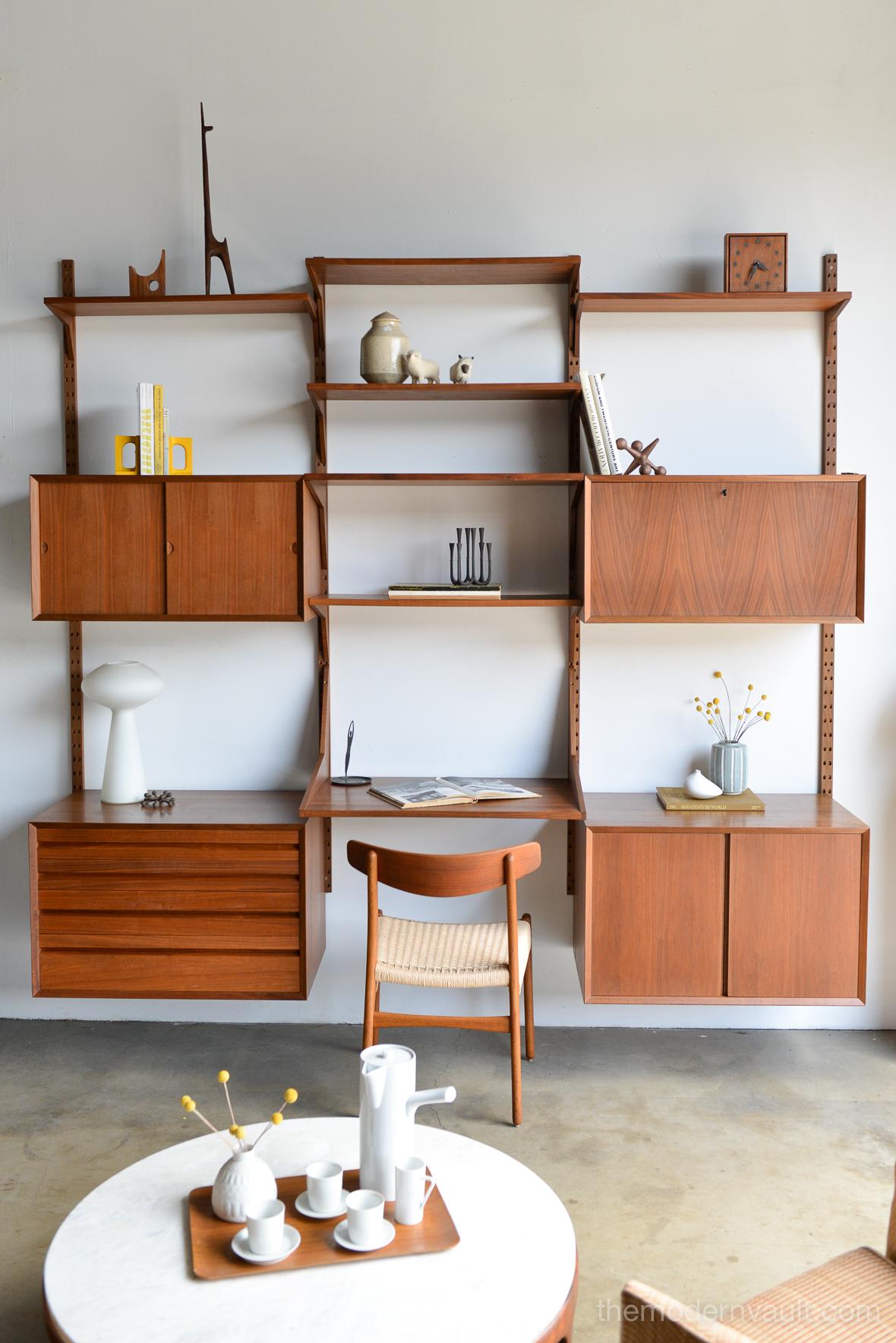 Walnut 3 bay wall unit by Poul Cadovius, Denmark 1970. Very good original condition includes all cabinets and shelves as shown: Very good original condition with only slight wear, unrestored. Marked Made in Denmark on back edges of all shelves and