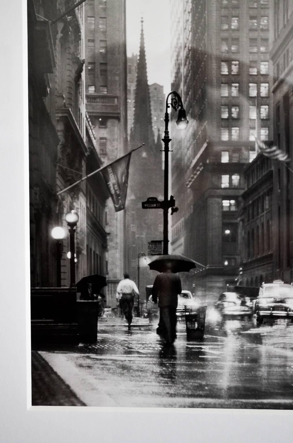 Original photograph of Wall Street in 1953 by renowned photographer and artist, Jerry Muller.

Photo of Jerry with this image in background is shown in photo #5. Professionally framed and matted with conservation glass.

Measures 21.5″ H x 17.5″