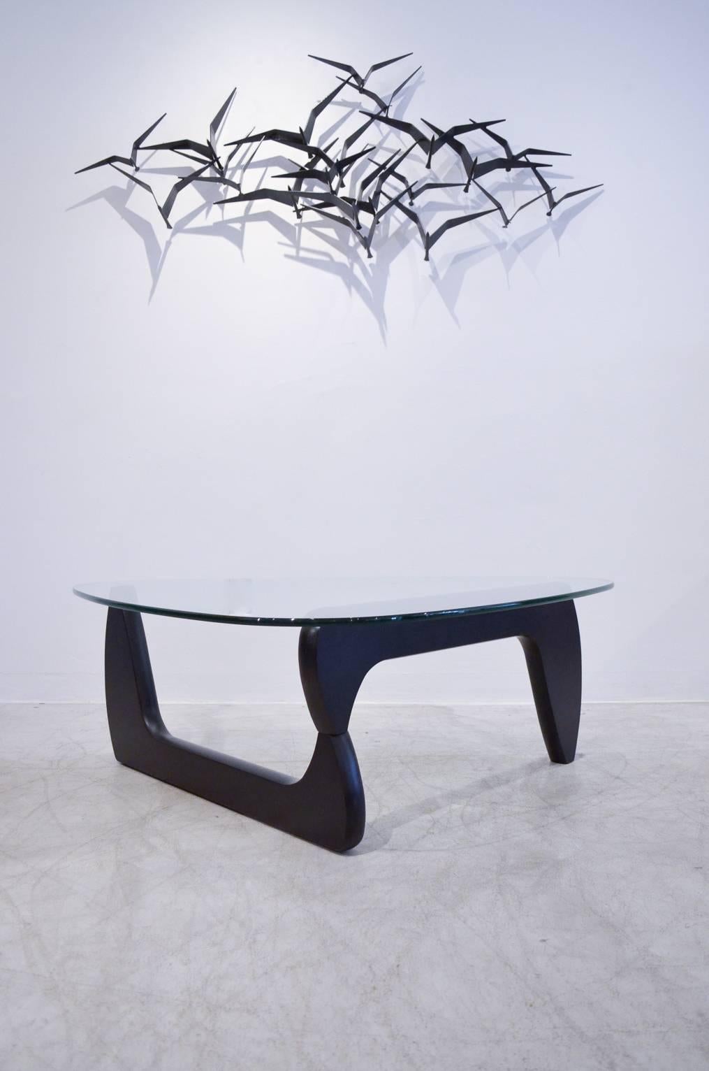 Beautiful sculptural glass and ebony wood coffee table by Isamu Noguchi for Knoll.

Glass is excellent with no chips or scratches