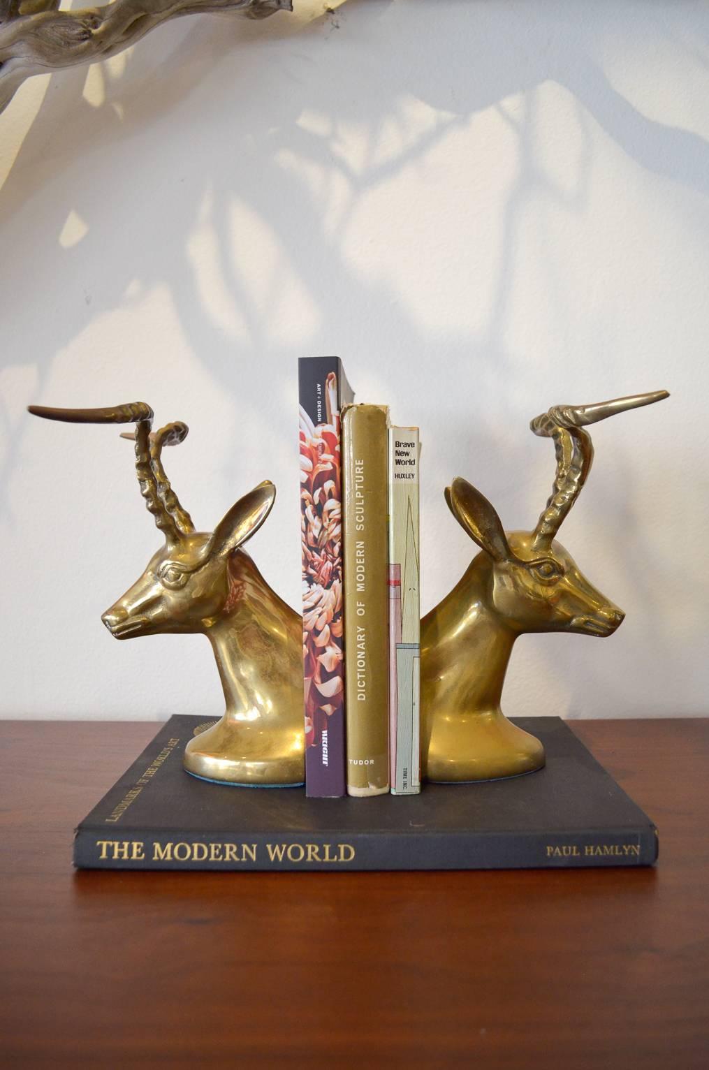 Beautiful hollywood regency pair of brass Gazelle or Antelope bookends in excellent vintage condition. Matching pair, felt on bottom to protect surfaces.  No pitting, only slight patina on horns.

Each Measure 8.5" H x 5" L x 3" W