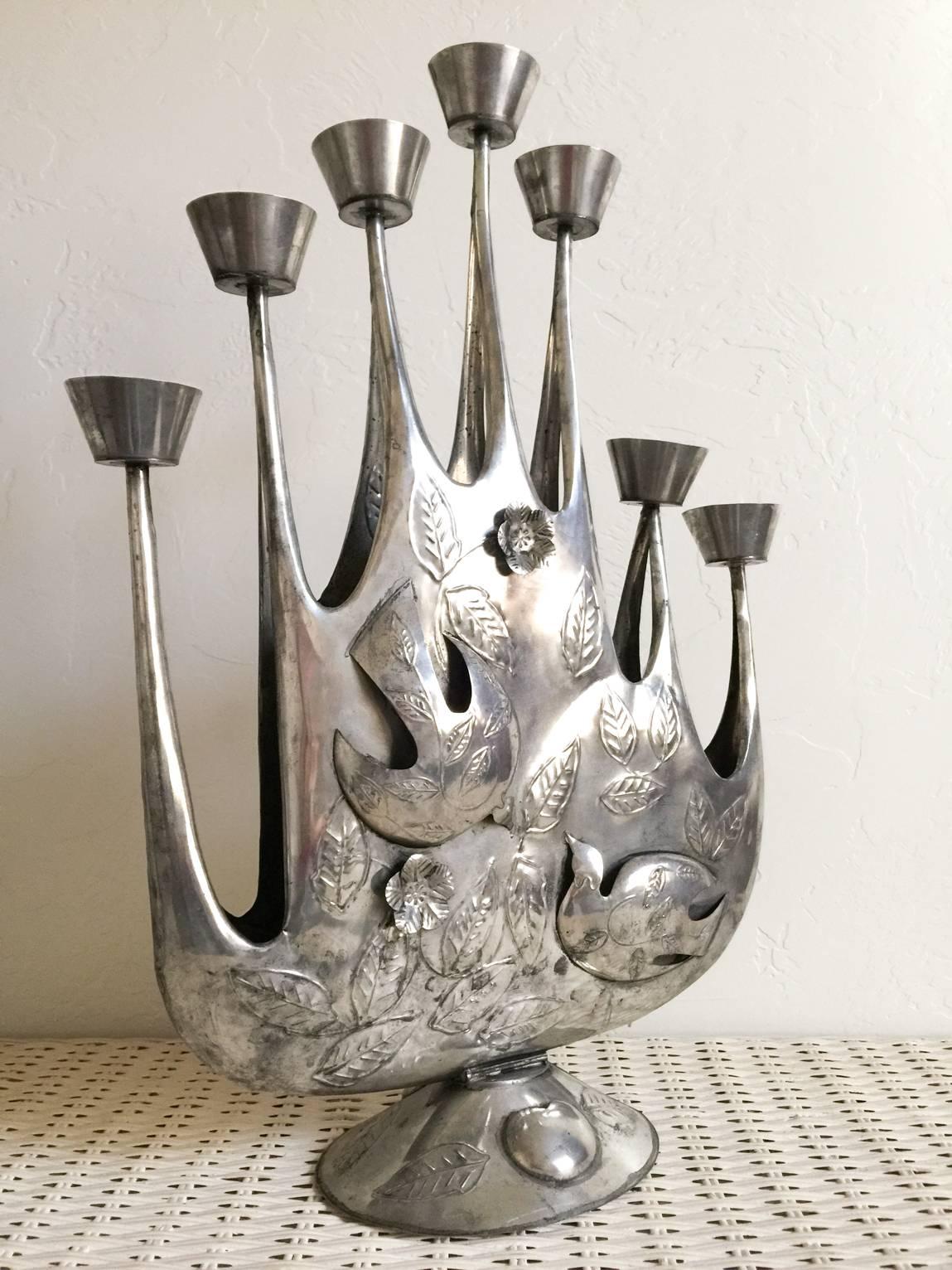 Incredibly rare and beautiful modernist tin candelabra by Mexican artist Gene Byron. Handmade of hand-hammered tin with lovely detail, this beautiful piece was also featured in the shipway Mexican modernism design books of the 1960s. 

Excellent