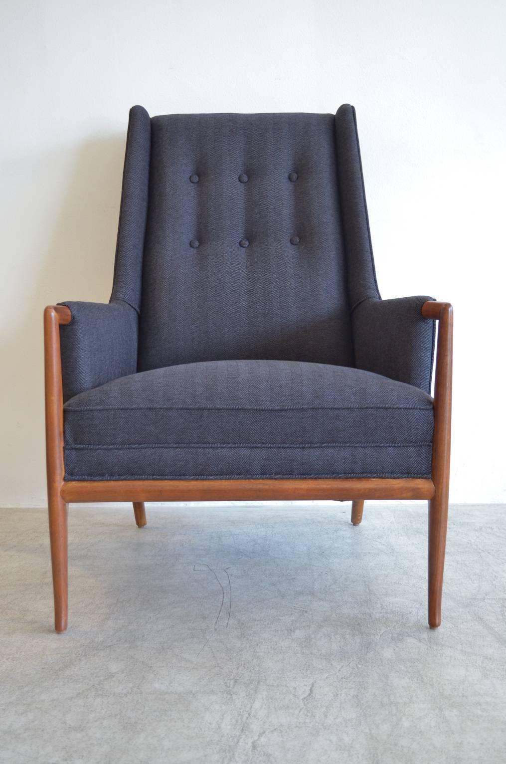 Elegant Robsjohn-Gibbings highback lounge chair with a beautiful exposed walnut frame and armrest. Highly desirable saber leg design, extremely comfortable and elegant. Fully restored in showroom condition with new charcoal grey herringbone wool