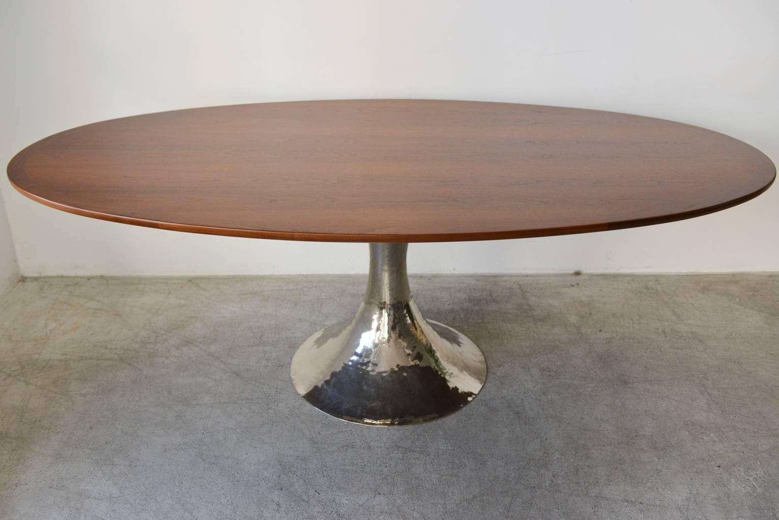 Beautiful walnut oval dining table with cross grain edging and hand-hammered nickel base.

Measures: 79