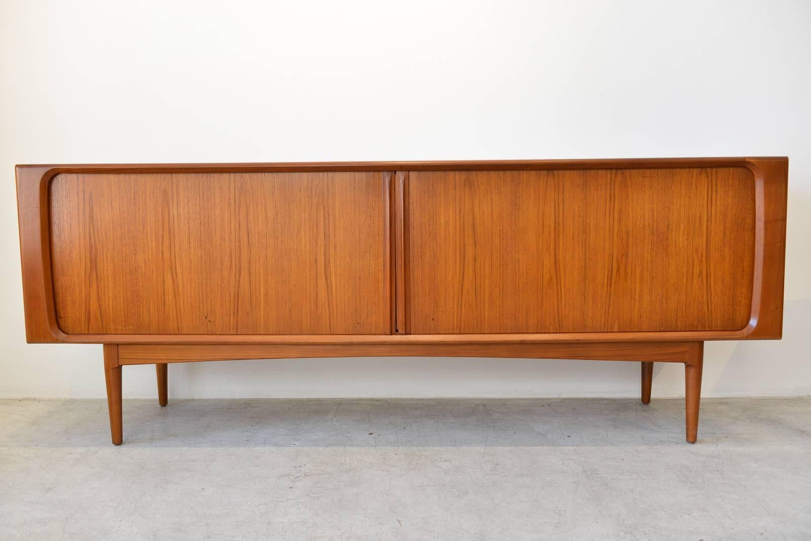 Bernhard Pedersen & Sons tambour door credenza, circa 1965. Beautifully restored in showroom perfect condition, this piece is also finished on the back.

Doors slide smoothly and includes inner adjustable shelving on both sides. Three drawers in