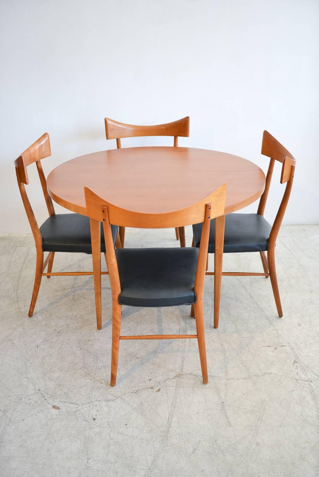 Paul McCobb model 1534 wingback (or bowtie) dining chairs, set of four, circa 1955. Solid maple with original black vinyl seats. Wood has been professionally restored. Matching dining table also available in a separate listing.

Measure 21