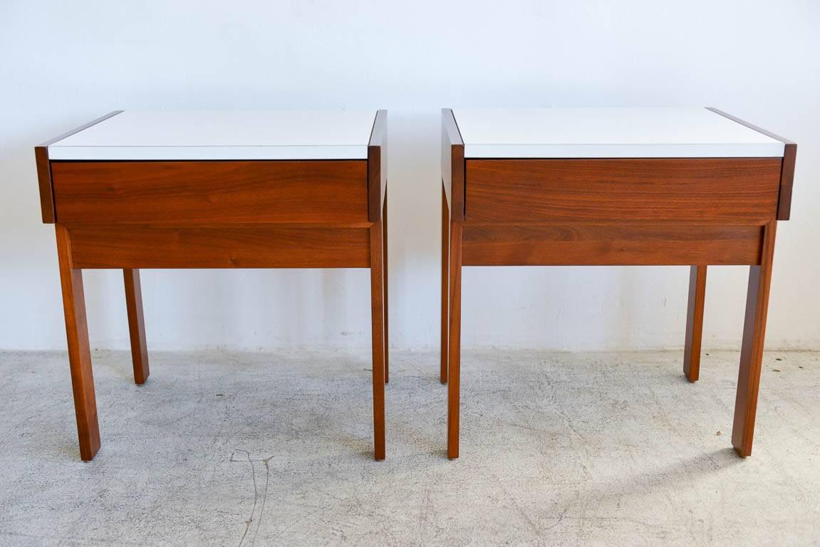 Martin Borenstein for Brown Saltman Walnut Nightstands with white laminate tops, ca. 1960.  Beautiful walnut grain with original white laminate tops in excellent condition.  Professionally restored in showroom perfect condition.  Rare pieces, hard