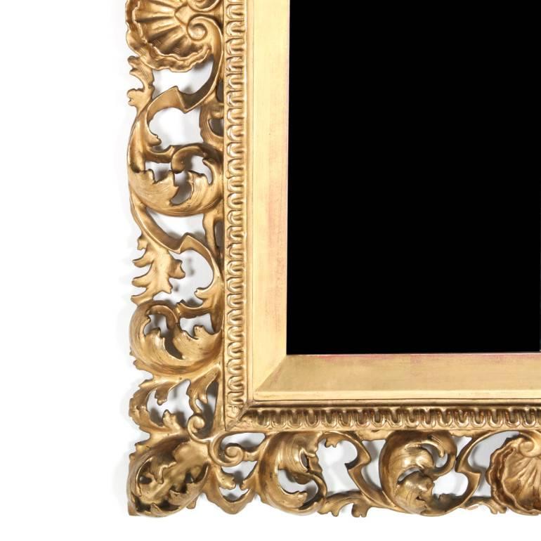 Deeply hand-carved Florentine mirror, circa 1880. The original gilding showing minor age-appropriate wear, measures 29″ wide x 36″ tall.