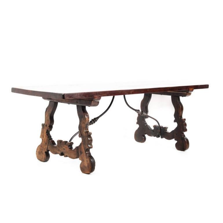 Large solid oak Italian trestle table with dark finish and gorgeous wrought-iron supports. Imported from France, late 19th century to early 20th century. Great solid-plank top with wonderful color and patina.