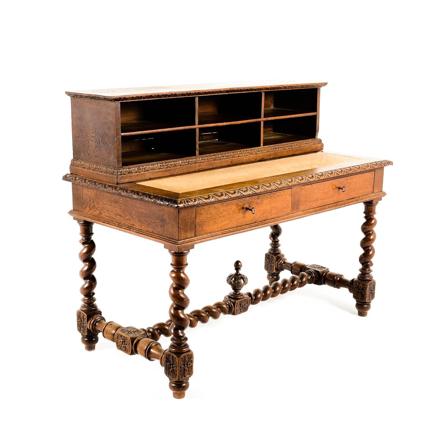 Antique French carved oak Henri II-style desk, with bold barley-twist legs, a leather pull-out writing surface and an upper section with three drawers, circa 1880.


 