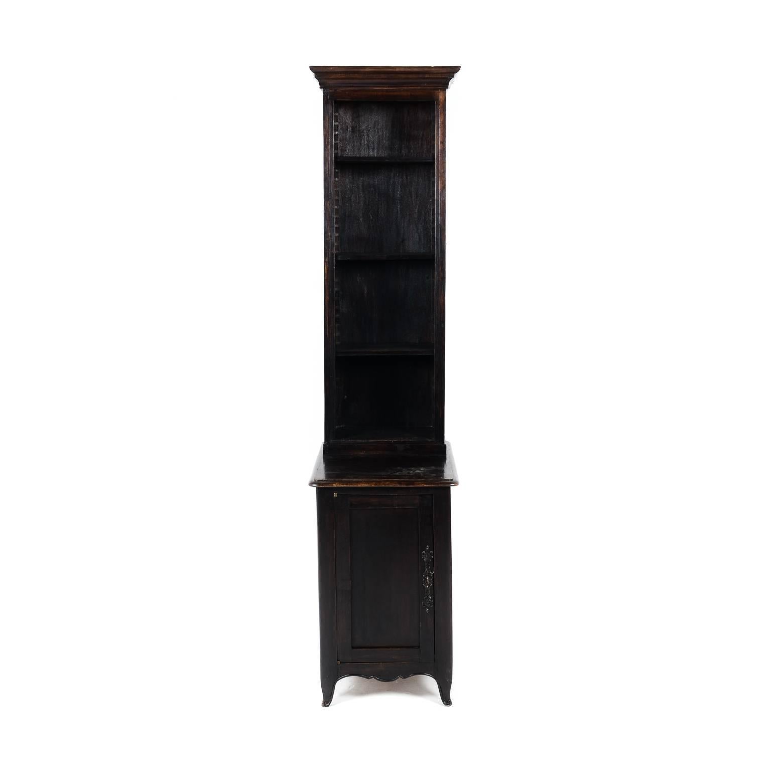Unusually narrow, dark oak bookcase with adjustable open shelves up and a cabinet below. Available in a pair or sold singly. French, circa 1920.


 