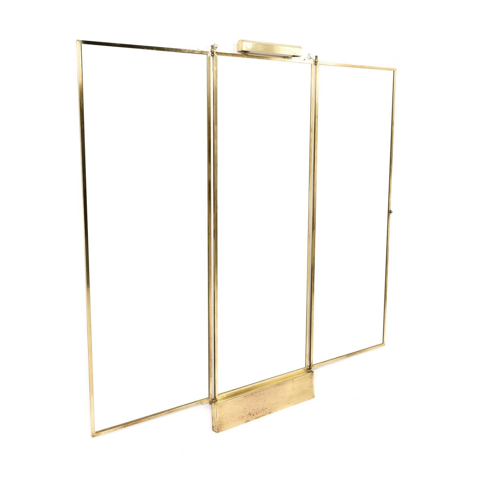 This is a rare large-scale solid brass mirror Brot from the prestigious French company in Paris. The glass is in like-new condition as it was specially treated to resist time, fading, and sea air. This is illuminated from the top to separate it in