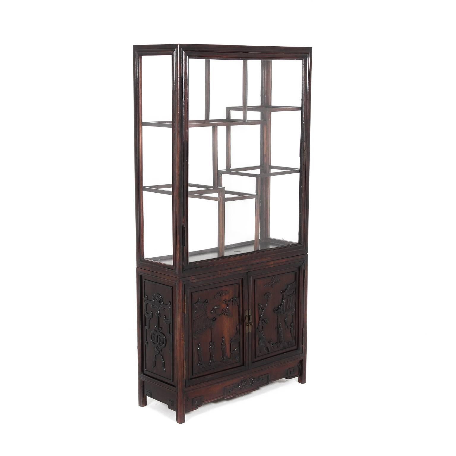 Antique Chinese display cabinet, circa 1900. Cabinet in Hong-Mu wood (or rosewood), with nicely-carved panels. From the late 19th or early 20th century. A shallow depth makes it a versatile piece throughout the home.

Hong-mu is a variety of