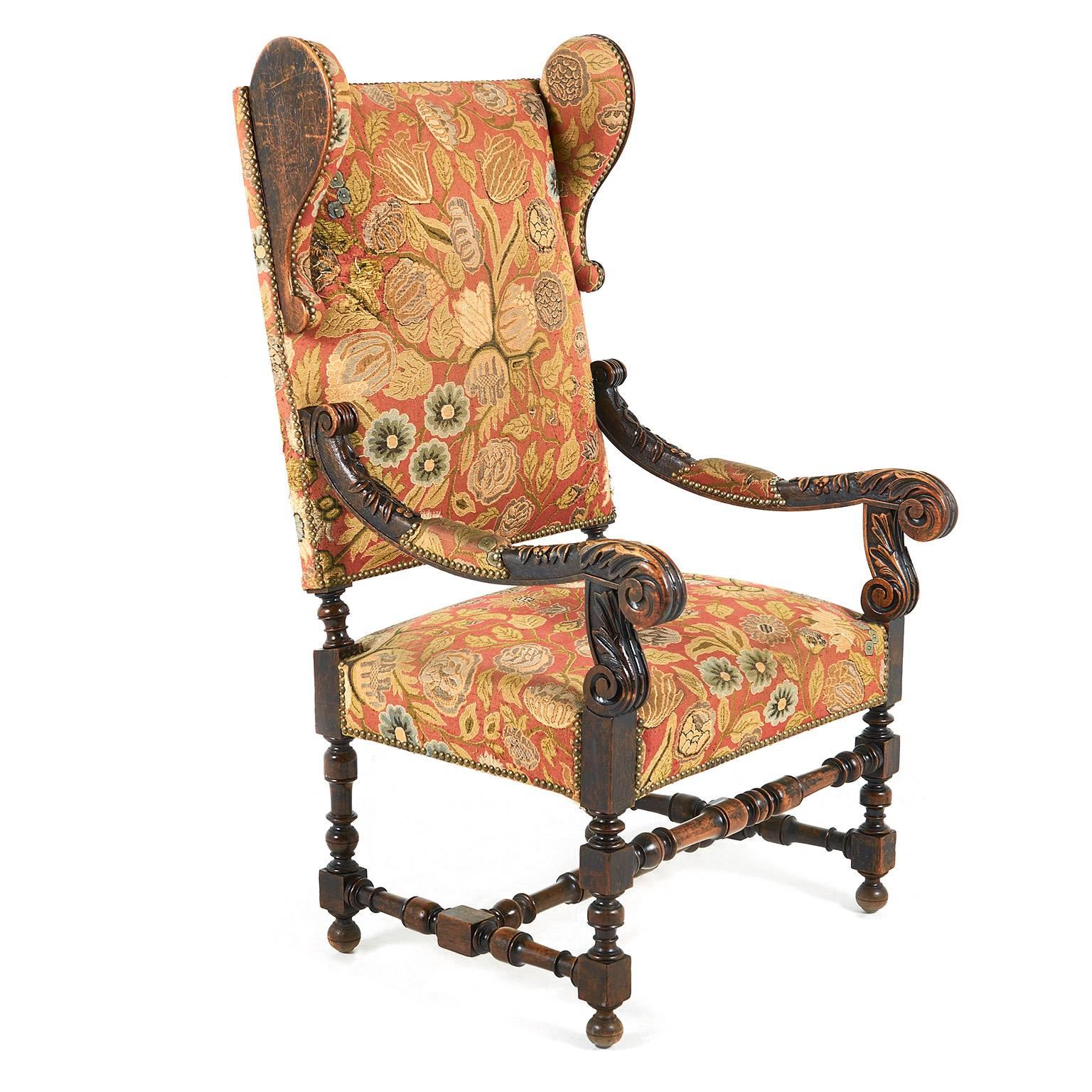 Antique, highly carved, Renaissance Revival-style French wing back chair in oak, circa 1890.

