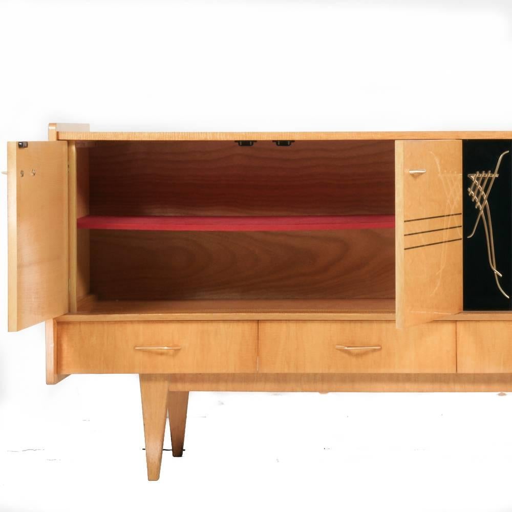 A French bird’s eye maple and lacquer buffet. Features hand-painted sliding glass door of Mount Fuji and two gazelles. Four fitted drawers. Handles are fantastic. 