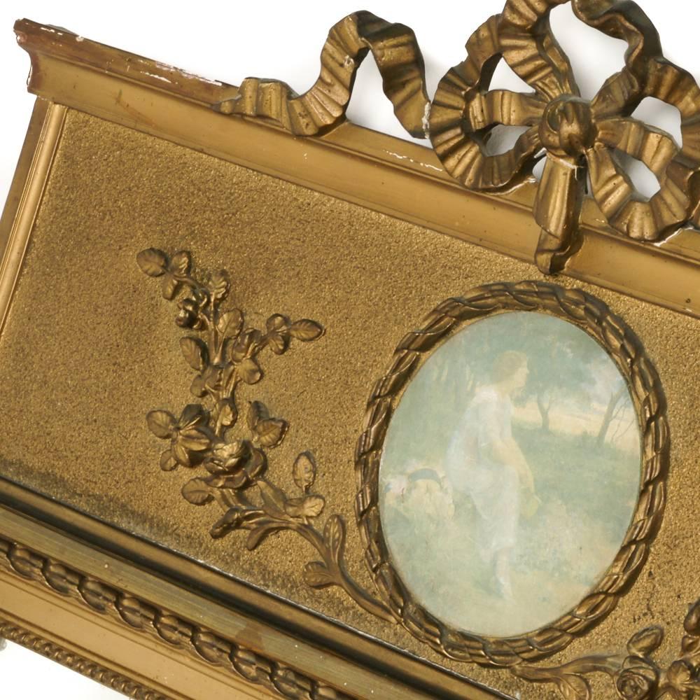 A French Louis XVI-style gilt trumeau with carved ribbon detailing. Circa 1930.




