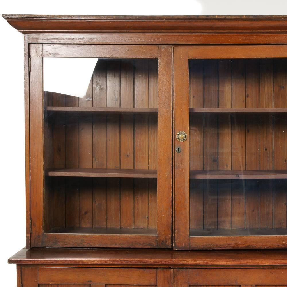 Unusually large, solid oak, shop cabinet originally from a local Vancouver pharmacy. 

Four glass doors enclosing adjustable upper shelving, with four lower panelled doors. A large and impressive piece.

