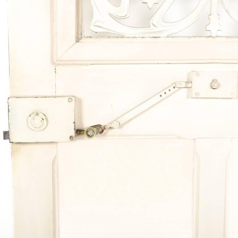 Rare, French Art Nouveau exterior door with original paint, circa 1915. The door has its' original hardware in good working condition, has a glass interior door that opens from the inside and original Art Nouveau wrought iron exterior window. It's