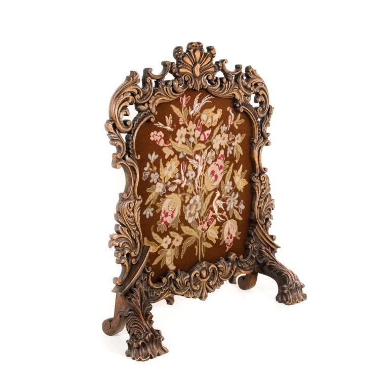 Highly-carved antique fireplace screen, 19th century.